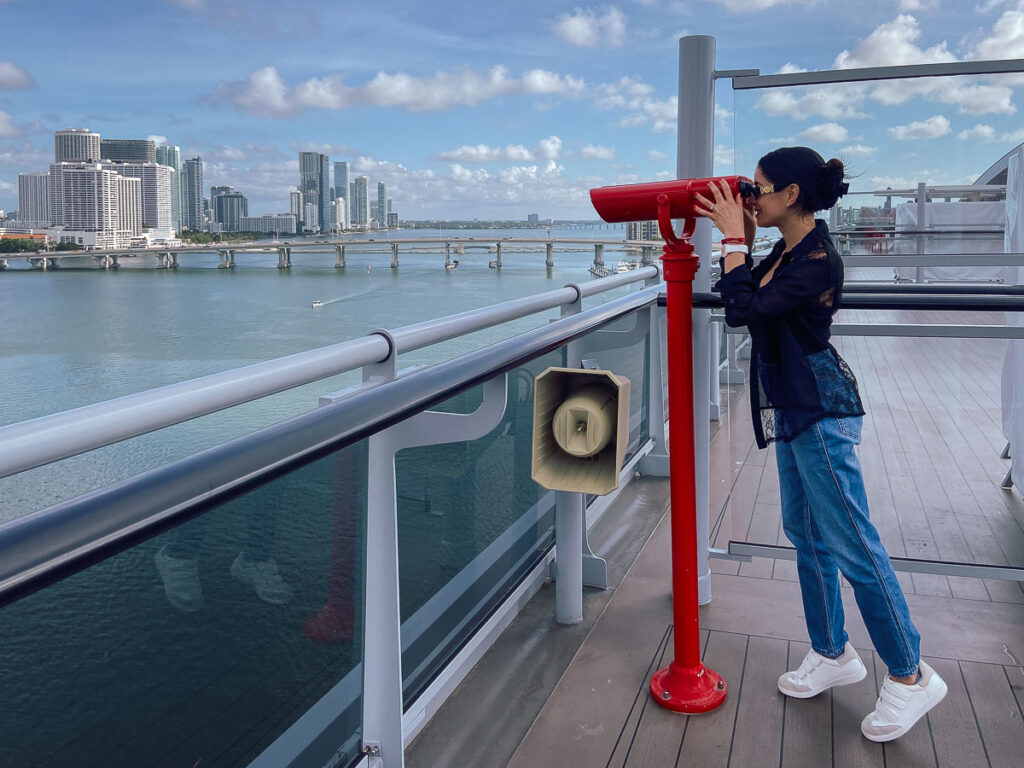 Using red binoculars which is one of the instagrammable Spots on virgin voyages