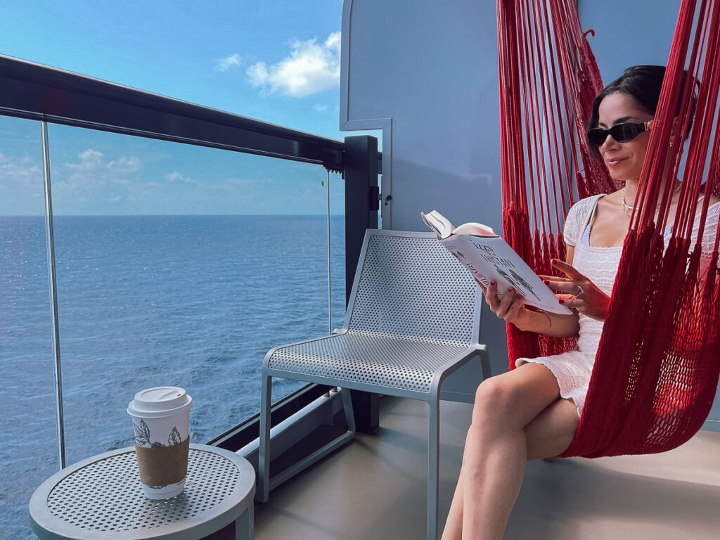 Reading A Book In The Sea Terrace Balcony virgin voyages cruise balcony hammock