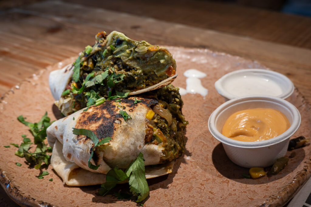 burrito breakfast dish with creamy sauces from Honest Green which is the house special breakfast burrito