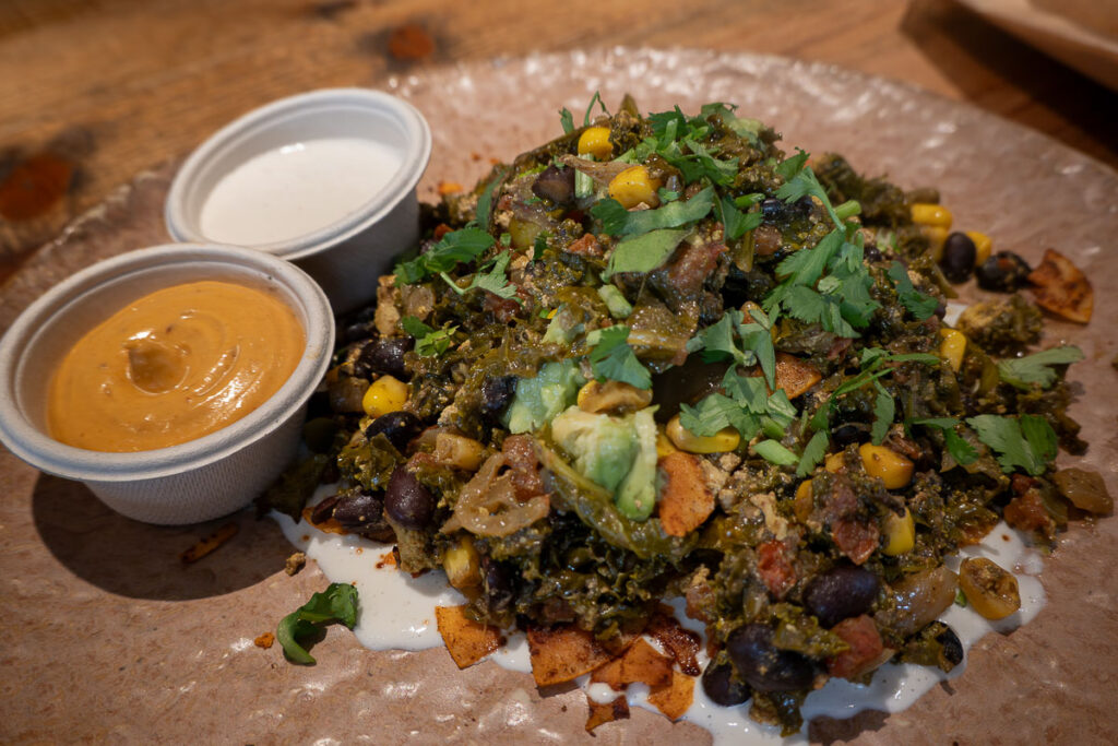 breakfast of dish made of beans, avocado, cilantro, corn and a creamy sauce from Honest Greens Valencia