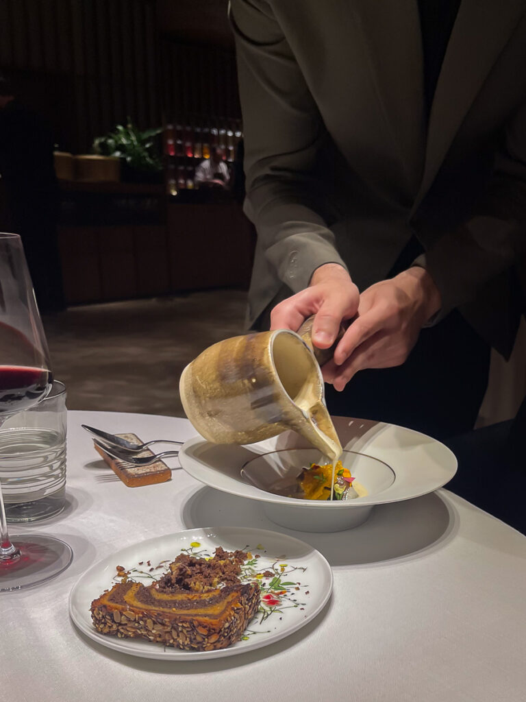a person serving a meal in Ricard Camarena restaurant in Valencia this is one of the dishes of the oxalis menu