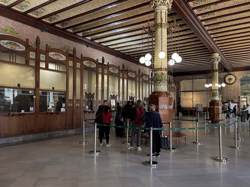 a group of people in the train ticket booth of the Valencia station north