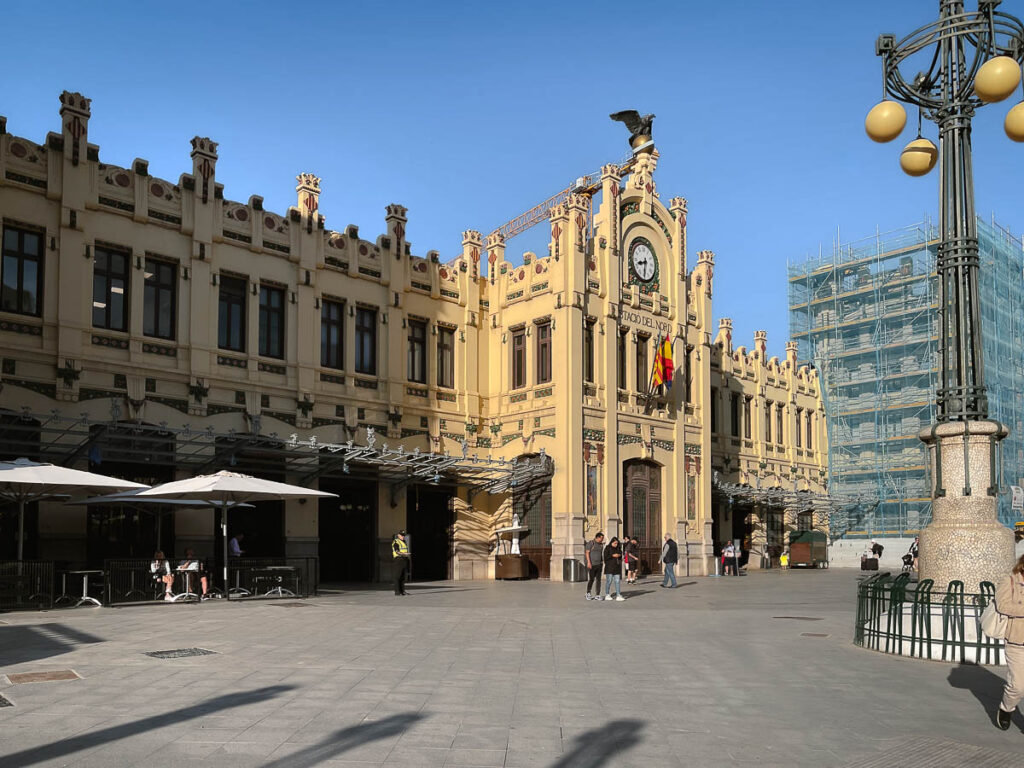 the exterior building of the Valencia nord train station with a clock on top
