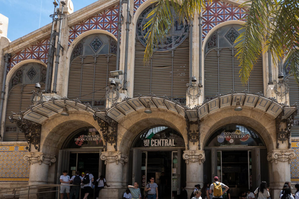a group of people outside of the central market building in Valencia