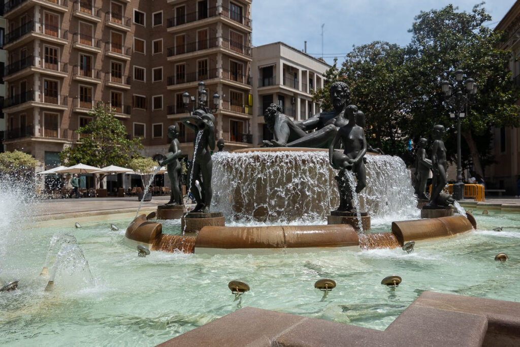 A fountain with statues in the middle of a city, this is the turia fountain in Valencia Spain