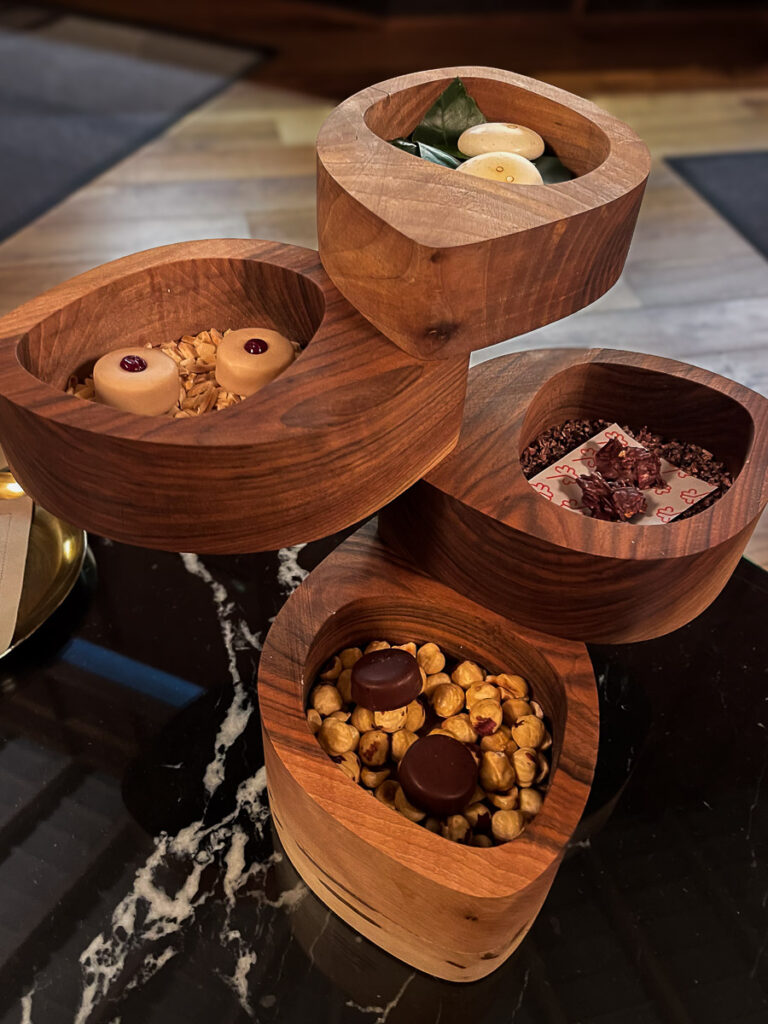 dark and white chocolates in four decorated wooden boxes