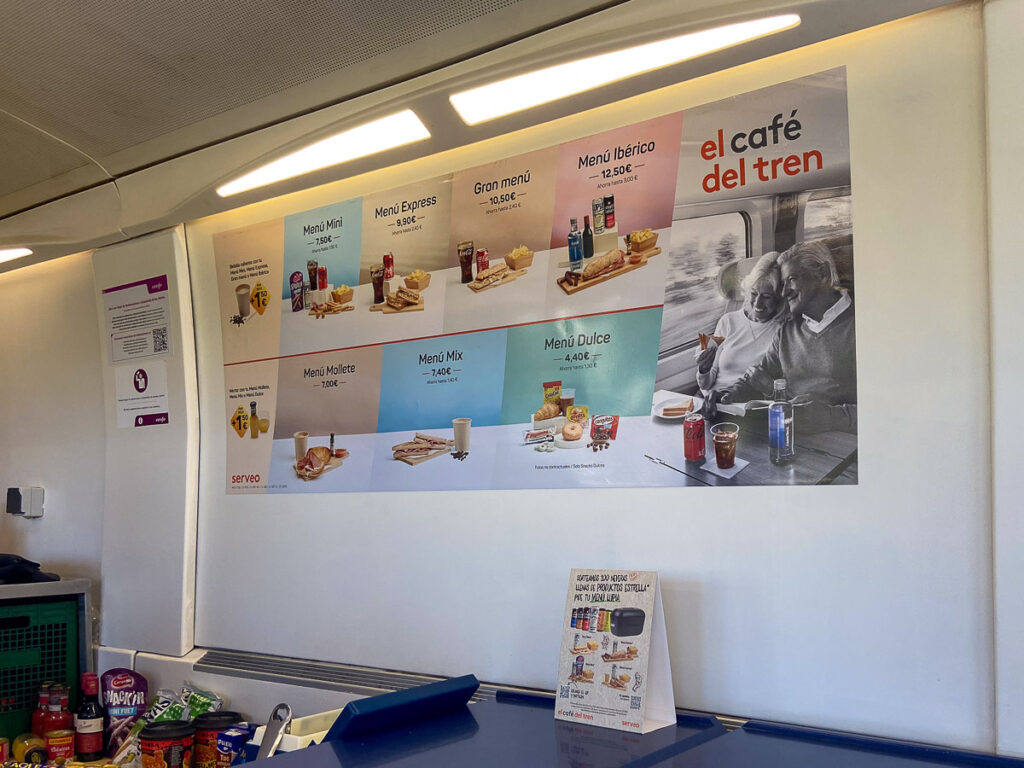 a wall poster with a food menu which is the renfe train menu of the train from Barcelona to Valencia