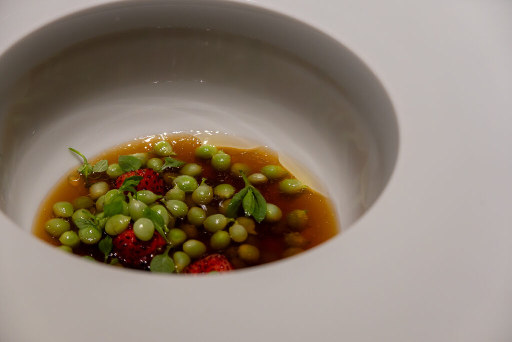 consomme potato peas strawberries in a white plate from Ricard Camarena 100% plant based menu Oxalis