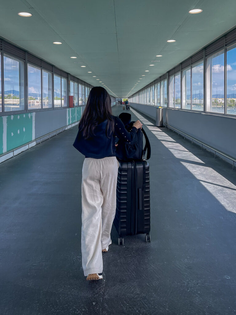 a female walking with luggage on her way from Barcelona airport to Barcelona Sants