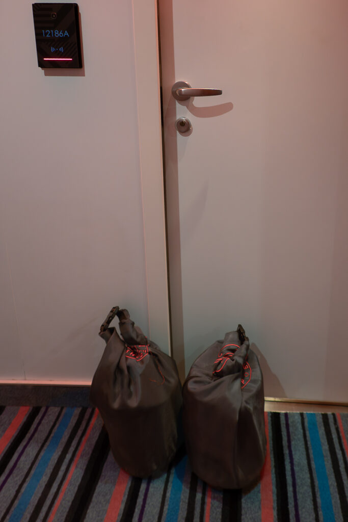 ship eats Virgin Voyages delivery bags in front of the cabin door