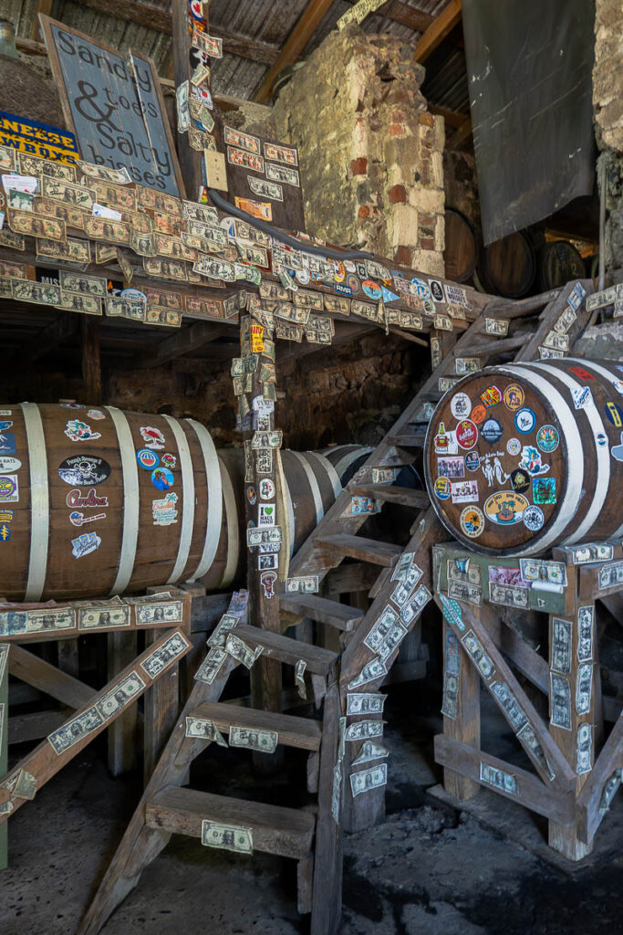 barrels and wood staircase which is the interior of Tortola rum distillery tour