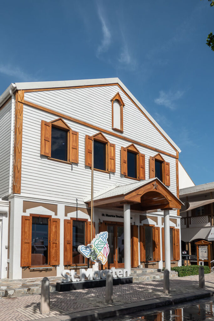 white wood building which represents the st maarten tourism bureau