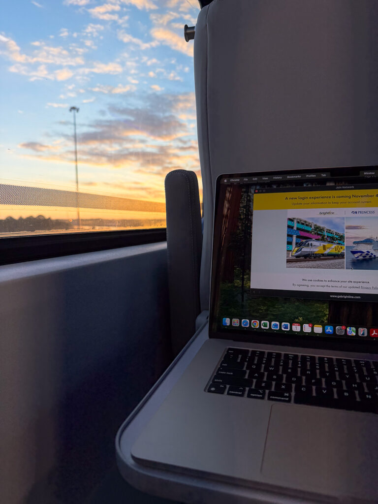 chair table and laptop in the brighline train orlando to miami