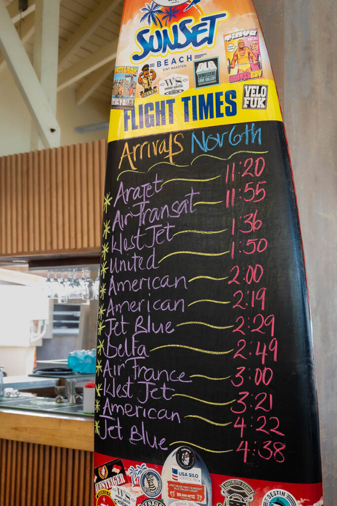 st maarten maho beach bar sunset beach showing the flight times