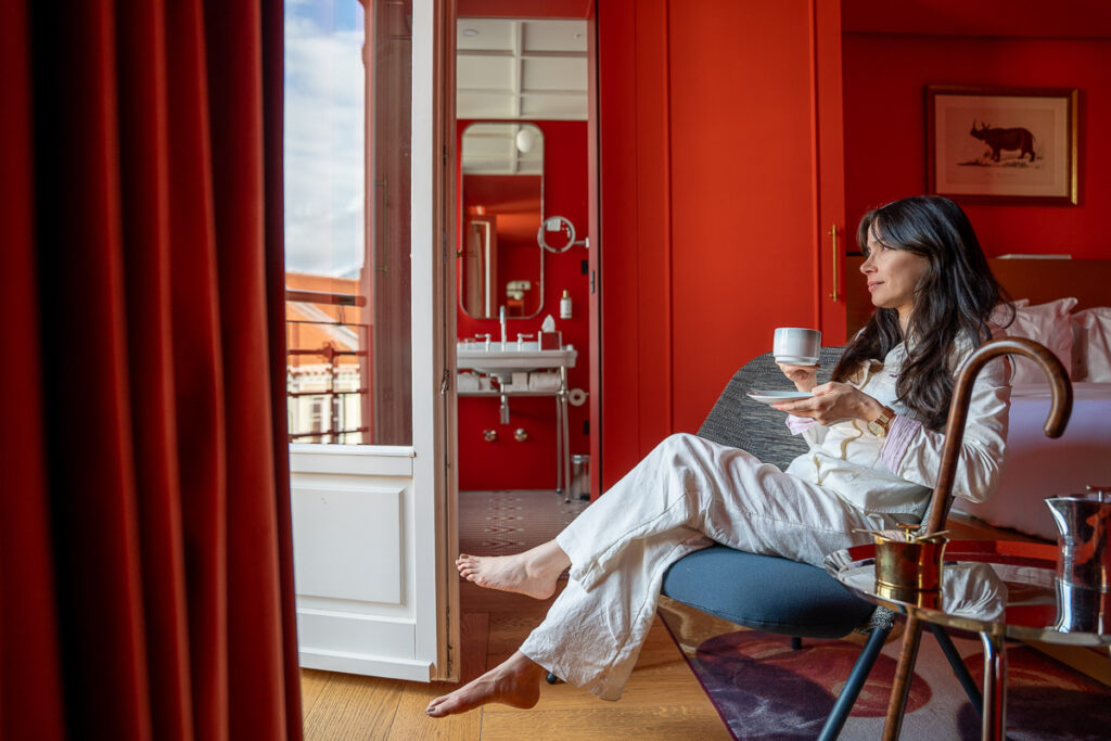 female drinking tea in the art balcony room of the Art Legacy hotel in Lisbon a Michelin key experience