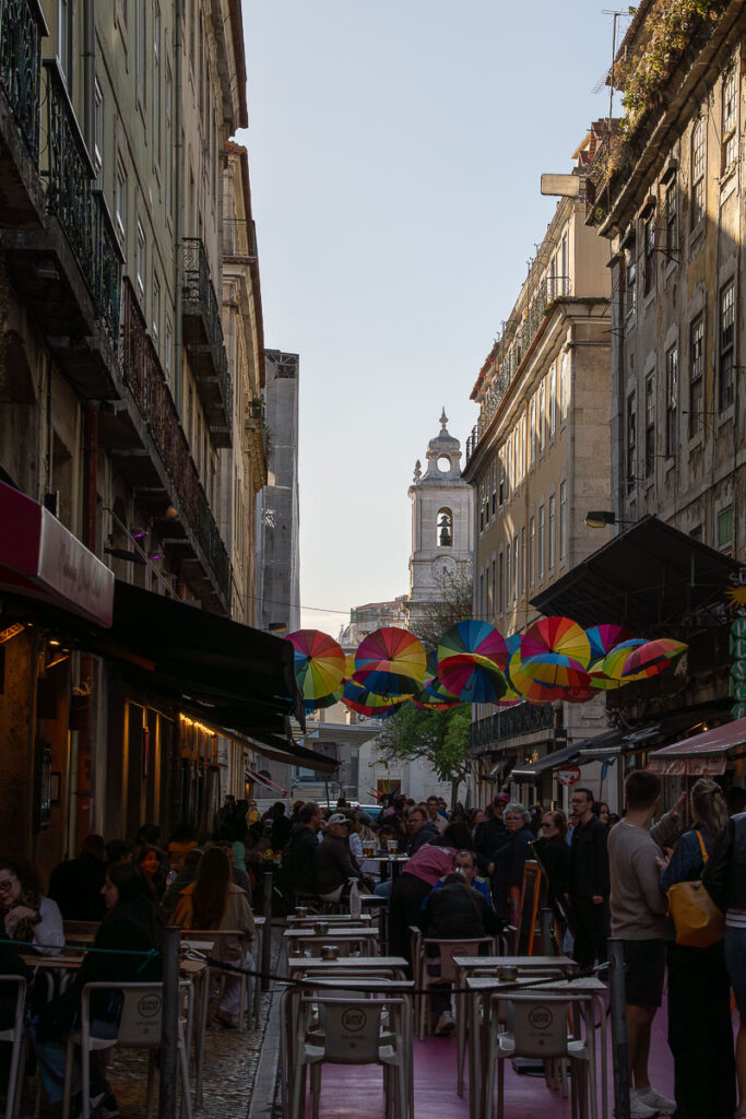 people in pink street Lisbon